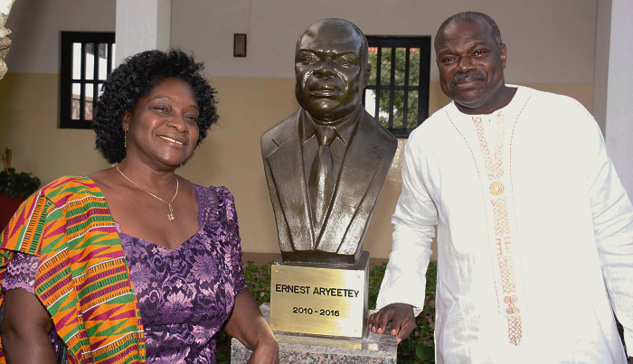  Prof. Ernest Aryeetey and his wife standing by his bust